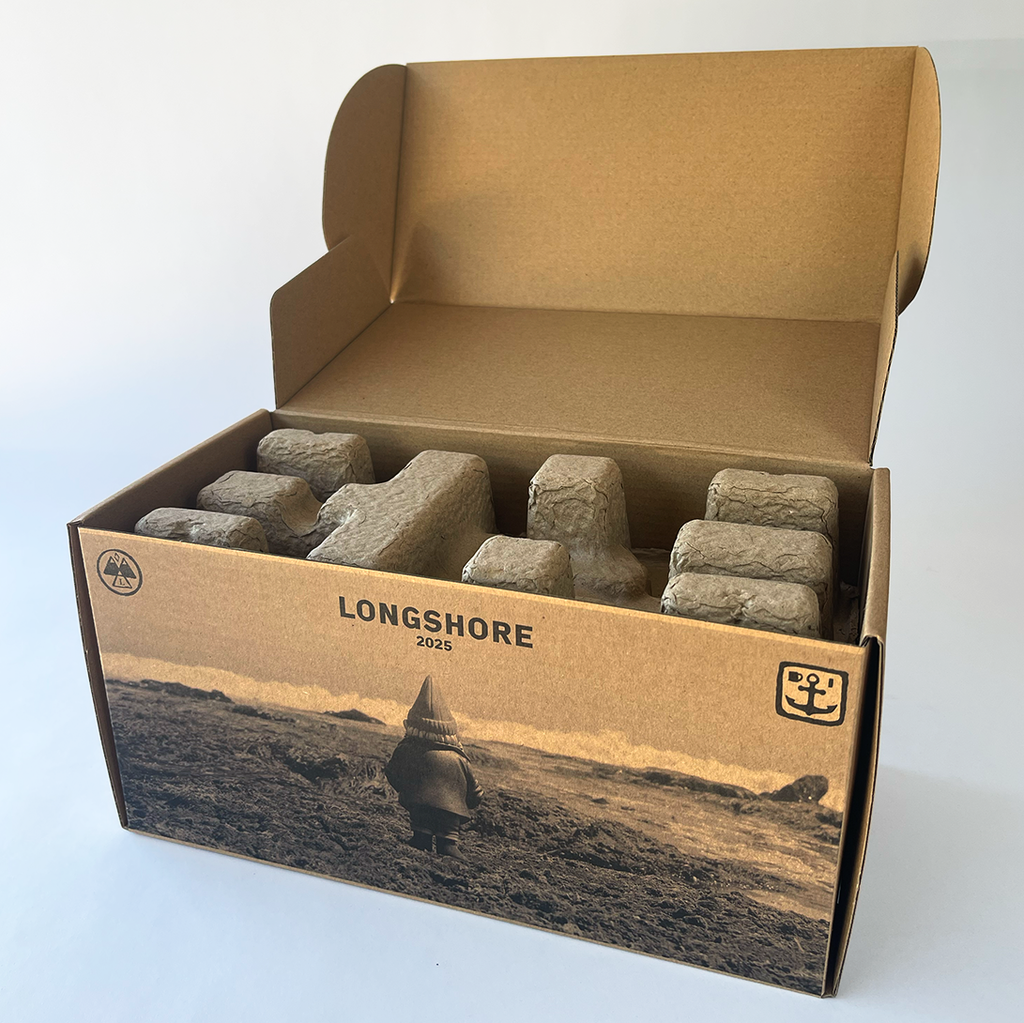 Open cardboard box with stones labeled 'Longshore 2025' 
