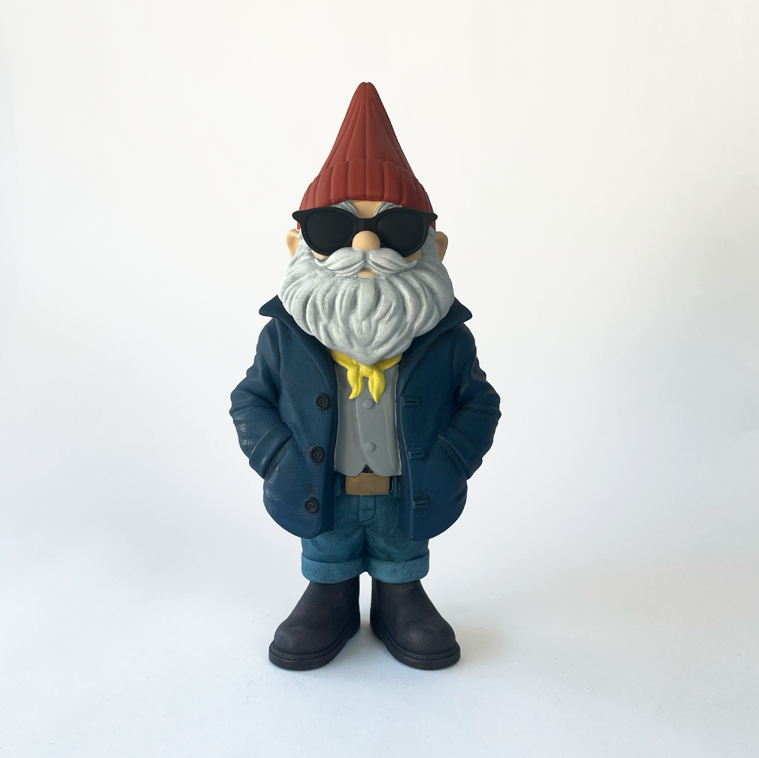 Gnome figurine wearing sunglasses, a coat, and a hat on a white background