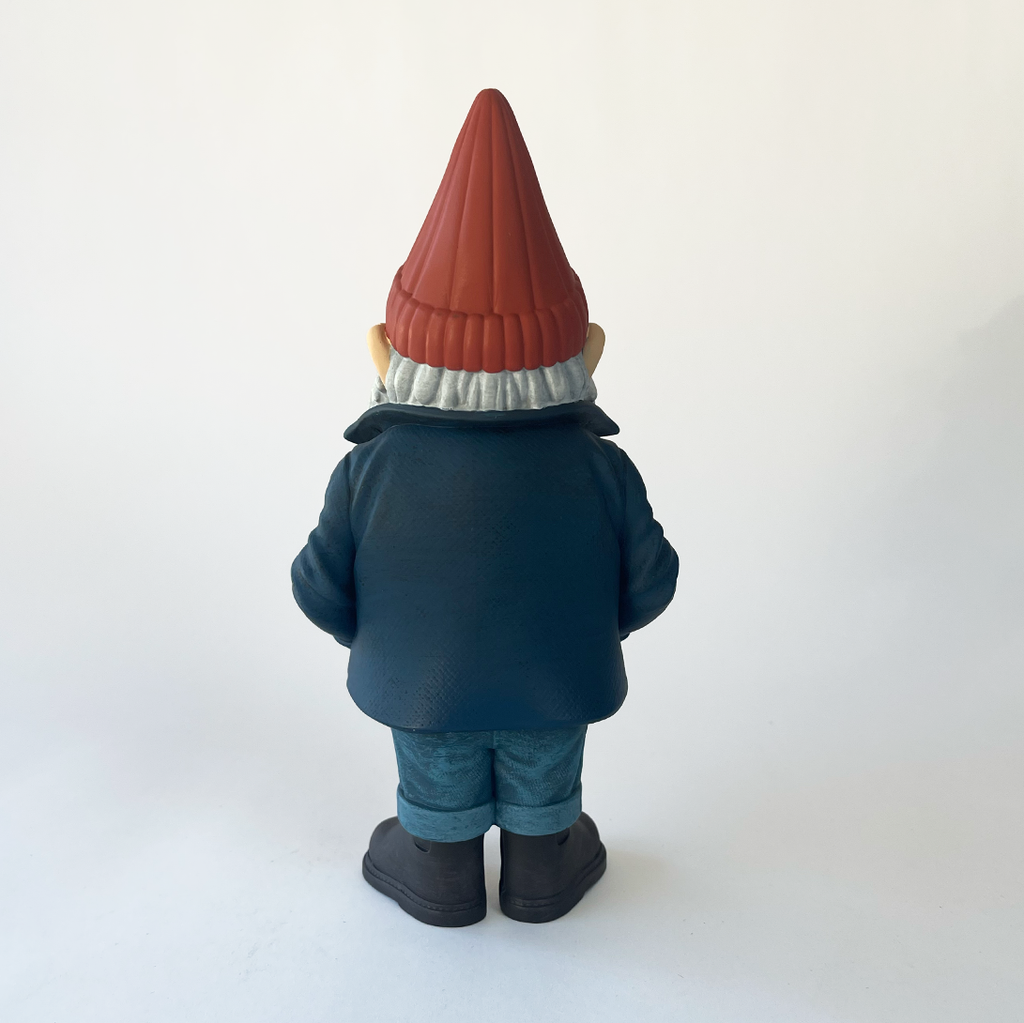 Gnome figurine with a red hat and blue coat on a white background