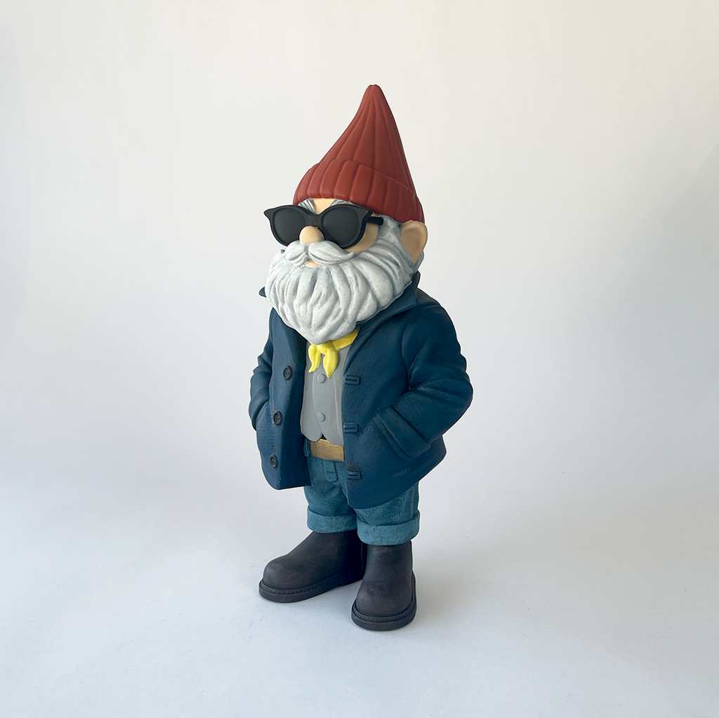 Gnome figurine wearing sunglasses, a red hat, and a blue coat on a white background
