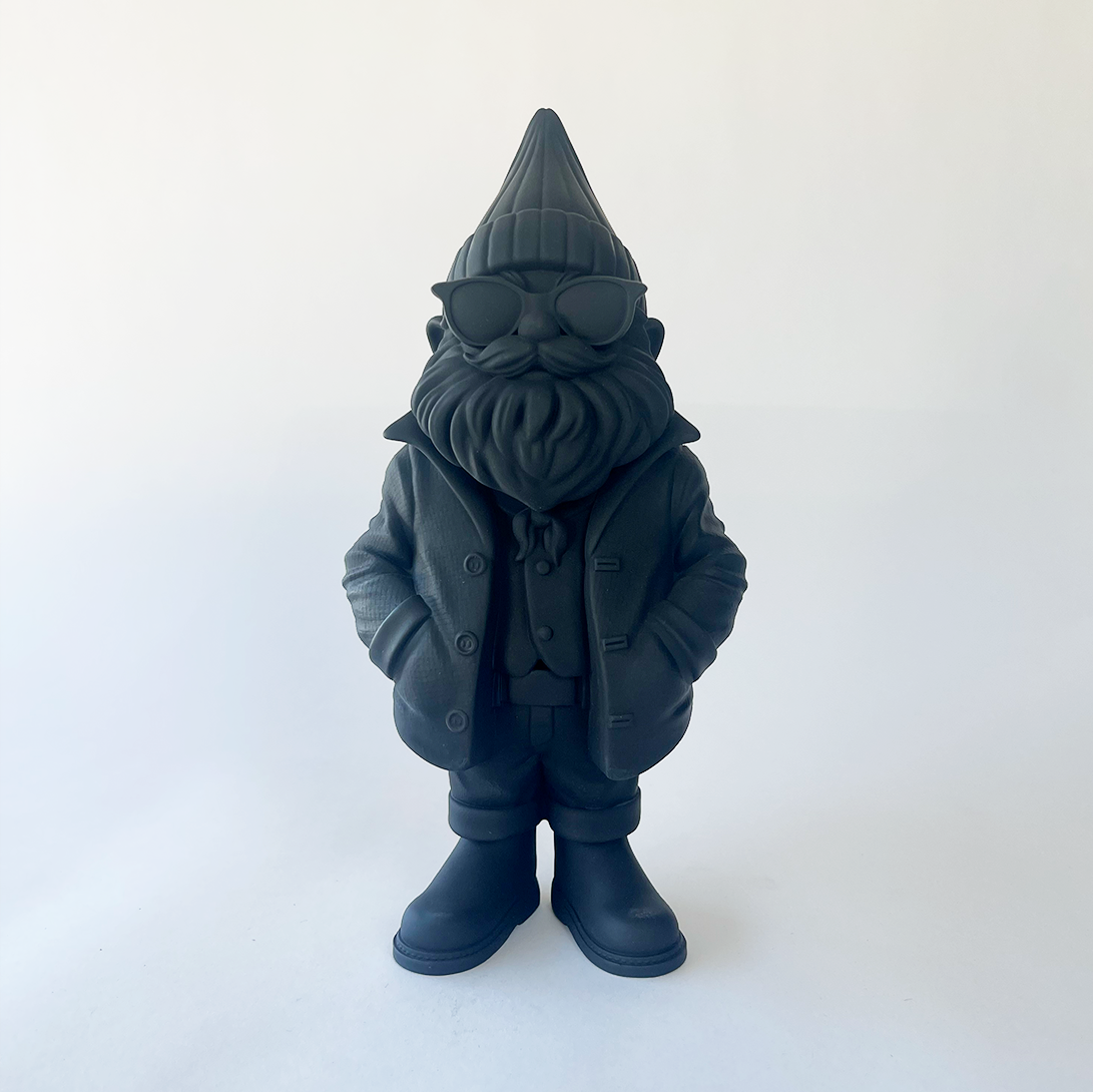 Black garden gnome figurine with a hat and sunglasses on a white background